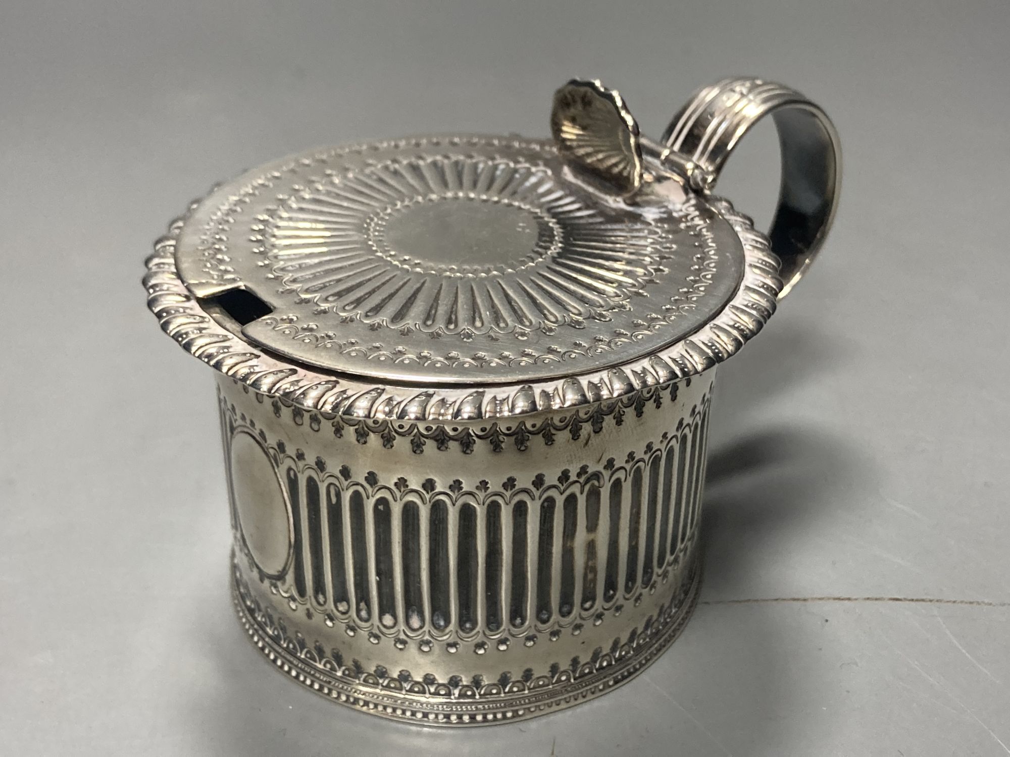 A George IV silver drum mustard, with blue glass liner, Emes & Barnard, London,1824, height 6.7cm, 145 grams.